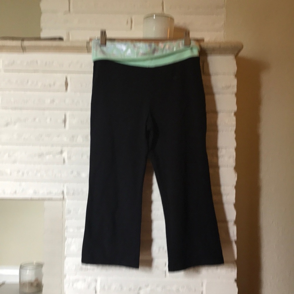 Black leggings with green top and silver design